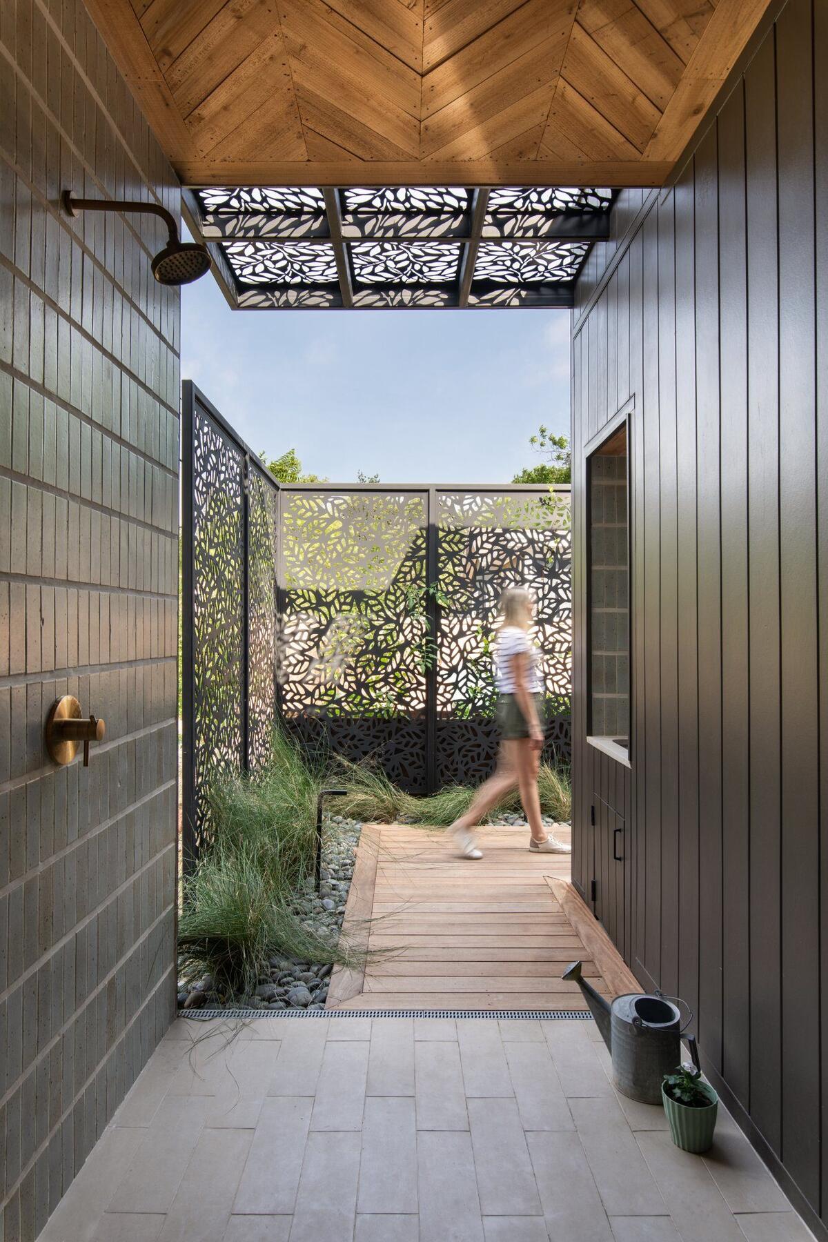 Custom outdoor shower with decorative metal screens